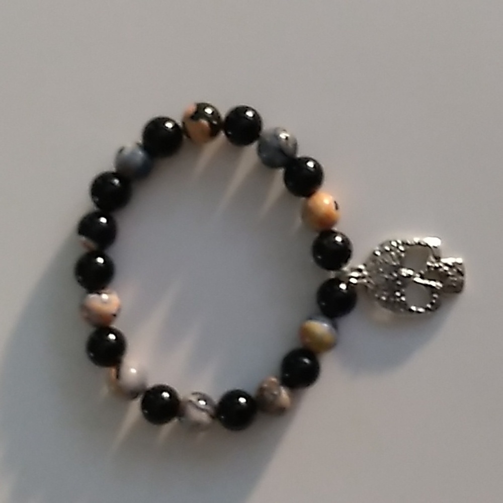 Orange and Black stretch bracelet with skull charm